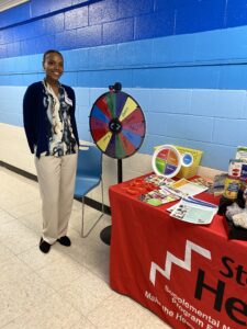 Keilah standing near table with promotional items